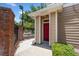 Cozy front entrance featuring a vibrant red door and brick accents at 1101 Vintage Village Ln # 101, Ocoee, FL 34761