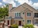 Charming two-story townhouse with neutral siding, complemented by a well-maintained landscape at 1101 Vintage Village Ln # 101, Ocoee, FL 34761