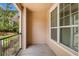 Covered patio featuring large window and black iron railing at 1101 Vintage Village Ln # 101, Ocoee, FL 34761
