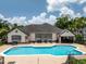 Community pool featuring multiple lounge chairs and a covered outdoor space at 1101 Vintage Village Ln # 101, Ocoee, FL 34761
