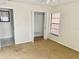 Bedroom view with a window, bi-fold closet doors, and ensuite bath access at 1110 Woodbine Street, Fern Park, FL 32730