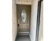 Close-up of a brown front door with an oval decorative glass insert at 1110 Woodbine Street, Fern Park, FL 32730