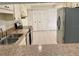Open kitchen featuring stainless steel appliances and white cabinets at 1110 Woodbine Street, Fern Park, FL 32730