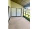 Enclosed back porch with sliding glass doors, screened windows and concrete flooring at 1110 Woodbine Street, Fern Park, FL 32730