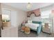 Charming bedroom with a whimsical touch, featuring a lovely daybed and decorative floral accents at 11429 Nona Sound St, Orlando, FL 32832