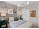 Well-designed bedroom featuring a cozy bed, decorative wall art, and ample natural light at 11429 Nona Sound St, Orlando, FL 32832