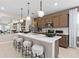 Well-appointed kitchen with stylish pendant lighting, a center island with seating, and modern appliances at 11429 Nona Sound St, Orlando, FL 32832