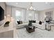 Well-lit living room with a chic chandelier, cozy sectional sofa, and elegant decor for relaxing or entertaining at 11429 Nona Sound St, Orlando, FL 32832