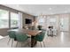 Open-concept living space includes dining area with modern table, chairs, and a view of the inviting living room at 11429 Nona Sound St, Orlando, FL 32832