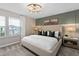 A main bedroom features a decorative panel wall and an elegant light fixture at 11429 Nona Sound St, Orlando, FL 32832