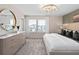 A main bedroom has a dresser beneath a mirror by the window and green accent wall at 11429 Nona Sound St, Orlando, FL 32832