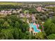 Expansive aerial view of the community with clubhouse, pool, and mature trees at 1200 Ironsmith Dr # 508, Celebration, FL 34747