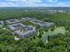 Beautiful aerial view of the condo community and its serene lake surrounded by a lush green tree line at 1200 Ironsmith Dr # 508, Celebration, FL 34747