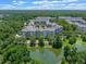 Scenic aerial view of multi-Gathering buildings surrounded by lush greenery and a tranquil pond at 1200 Ironsmith Dr # 508, Celebration, FL 34747