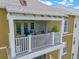 Overhead shot of cozy balcony with outdoor seating area with plants, and wooden pergola awning at 1200 Ironsmith Dr # 508, Celebration, FL 34747