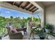 Relaxing balcony with comfortable seating and lush green views beyond the railing, shaded by a wooden awning at 1200 Ironsmith Dr # 508, Celebration, FL 34747