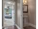 View of a white pedestal sink and mirror in a light-filled bathroom, looking into the bedroom at 1200 Ironsmith Dr # 508, Celebration, FL 34747