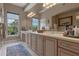 Bathroom with dual sinks, large vanity, and a big mirror reflecting natural light and wooded views at 1200 Ironsmith Dr # 508, Celebration, FL 34747