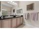 Bathroom with granite countertop double vanity, decorative mirrors and lighting, next to the glass shower at 1200 Ironsmith Dr # 508, Celebration, FL 34747