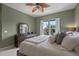 Bedroom featuring an olive color scheme and a dark wood dresser beneath a decorative mirror at 1200 Ironsmith Dr # 508, Celebration, FL 34747