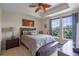 Tranquil bedroom with tray ceiling, a ceiling fan, and serene natural light streaming through the windows at 1200 Ironsmith Dr # 508, Celebration, FL 34747