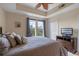 Inviting bedroom with large windows offering lush views of the surrounding nature and a television set at 1200 Ironsmith Dr # 508, Celebration, FL 34747