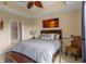 Cozy bedroom features a sunset painting, an accent chair and a view of the ensuite bathroom at 1200 Ironsmith Dr # 508, Celebration, FL 34747
