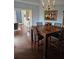 Elegant dining room with a wooden table set, stylish chandelier, and view to the Gathering room at 1200 Ironsmith Dr # 508, Celebration, FL 34747