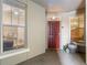Welcoming entryway with a red door, natural light and stylish decor elements at 1200 Ironsmith Dr # 508, Celebration, FL 34747