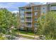 Inviting exterior view of an well-maintained condominium building surrounded by lush greenery at 1200 Ironsmith Dr # 508, Celebration, FL 34747
