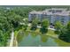 Exterior view of lakeside condos with a backdrop of trees and view of the community's walking path at 1200 Ironsmith Dr # 508, Celebration, FL 34747