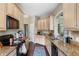 Traditional kitchen featuring tan cabinetry, granite countertops and stainless-steel appliances at 1200 Ironsmith Dr # 508, Celebration, FL 34747