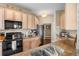 Traditional kitchen featuring tan cabinetry, granite countertops and stainless-steel appliances at 1200 Ironsmith Dr # 508, Celebration, FL 34747