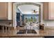 Kitchen with granite countertops, tan cabinets, and a stone archway looking into the living room at 1200 Ironsmith Dr # 508, Celebration, FL 34747