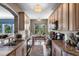 Galley kitchen with granite countertops, hardwood floors, and stainless steel appliances, with a breakfast nook at 1200 Ironsmith Dr # 508, Celebration, FL 34747