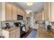 Galley kitchen with granite countertops, hardwood floors, and stainless steel appliances at 1200 Ironsmith Dr # 508, Celebration, FL 34747