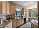 Galley kitchen with granite countertops, hardwood floors, and stainless steel appliances at 1200 Ironsmith Dr # 508, Celebration, FL 34747