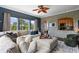Spacious living room with a stone accent wall, oversized couch, and many windows with a view at 1200 Ironsmith Dr # 508, Celebration, FL 34747