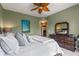 Relaxing primary bedroom suite with a dresser and a bed topped with decorative pillows at 1200 Ironsmith Dr # 508, Celebration, FL 34747