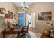 Comfortable office with a wood desk, chair, and art at 1200 Ironsmith Dr # 508, Celebration, FL 34747