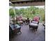 Relaxing patio with wicker furniture overlooking lush greenery and mature trees at 1200 Ironsmith Dr # 508, Celebration, FL 34747