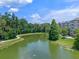 Gorgeous pond surrounded by greenery, including walking path and complex, creating an inviting community space at 1200 Ironsmith Dr # 508, Celebration, FL 34747