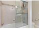 Elegant walk-in shower with tiled walls, glass door and chrome fixtures, and shampoo shelf at 1200 Ironsmith Dr # 508, Celebration, FL 34747