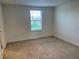 Bright bedroom featuring plush carpeting, a window with blinds, and neutral paint at 12035 Holystone St, Winter Garden, FL 34787