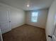 Comfortable bedroom with neutral walls, carpeting, and a window for natural light at 12035 Holystone St, Winter Garden, FL 34787