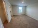 Cozy bedroom featuring neutral carpet, large window, and ample space at 12035 Holystone St, Winter Garden, FL 34787