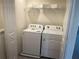 Bright laundry room featuring Whirlpool washer and dryer with wire rack shelving for storage at 12035 Holystone St, Winter Garden, FL 34787