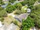 Aerial shot of the house showcasing roof detail, landscaping, and proximity to neighboring houses and trees at 13018 S Sunset Ter, Winter Garden, FL 34787