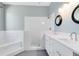 Bright bathroom with marble tile shower and bath, and dual sink vanity at 13018 S Sunset Ter, Winter Garden, FL 34787