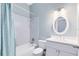 Clean bathroom with a shower-tub combo, a single sink vanity, and updated fixtures at 13018 S Sunset Ter, Winter Garden, FL 34787